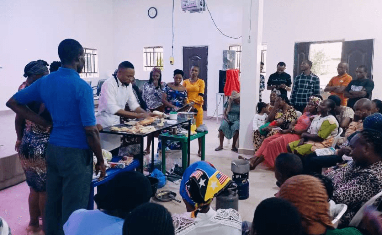 Facilitator speaking with participants during a practical workshop